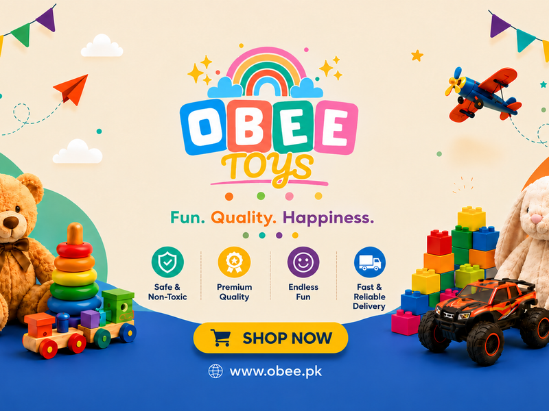 Promotional banner for Obbee Toys featuring a variety of children's toys including a teddy bear, a rabbit plush, a building block truck, a stacking toy, and a small toy car, set against a colorful cartoon background with a rainbow, bunting, and a 'SHOP NOW' button.